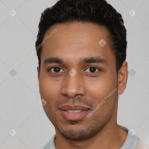 Joyful latino young-adult male with short  black hair and brown eyes