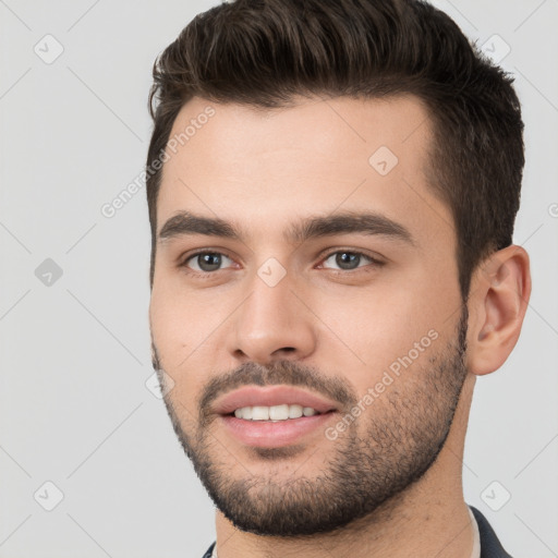 Joyful white young-adult male with short  brown hair and brown eyes