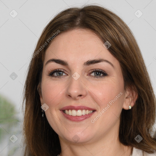 Joyful white young-adult female with medium  brown hair and green eyes