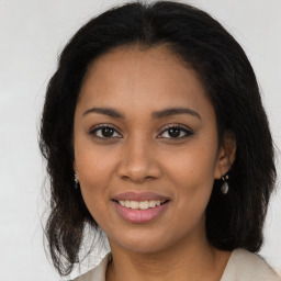 Joyful latino young-adult female with medium  brown hair and brown eyes