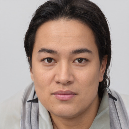 Joyful asian young-adult male with medium  brown hair and brown eyes