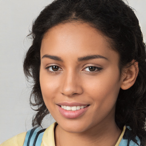 Joyful latino young-adult female with long  brown hair and brown eyes