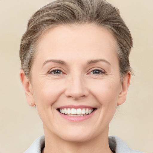 Joyful white adult female with short  brown hair and grey eyes