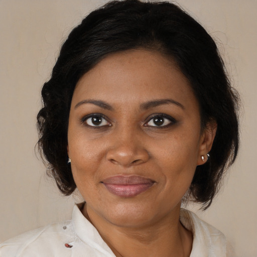 Joyful black adult female with medium  brown hair and brown eyes