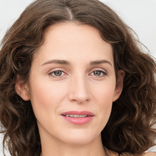 Joyful white young-adult female with long  brown hair and green eyes