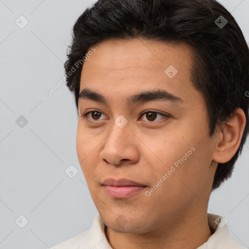 Joyful asian young-adult male with short  black hair and brown eyes