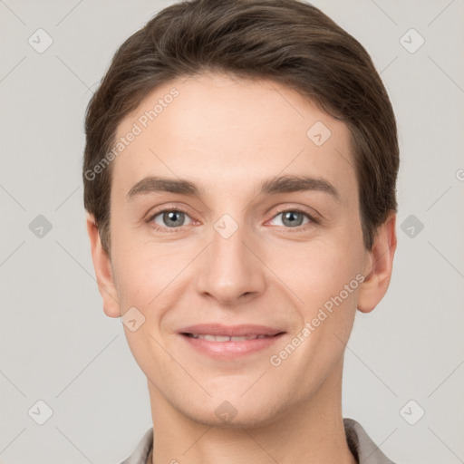 Joyful white young-adult male with short  brown hair and grey eyes