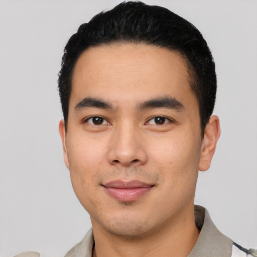 Joyful latino young-adult male with short  black hair and brown eyes