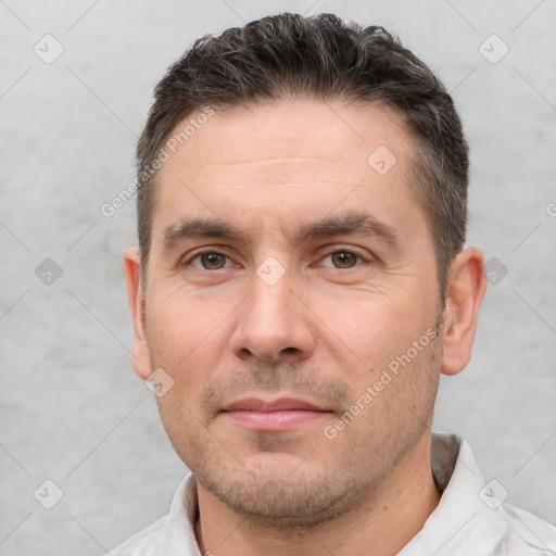 Joyful white adult male with short  brown hair and brown eyes