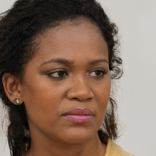 Neutral black young-adult female with long  brown hair and brown eyes
