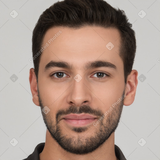 Joyful white young-adult male with short  black hair and brown eyes