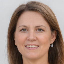 Joyful white adult female with long  brown hair and grey eyes