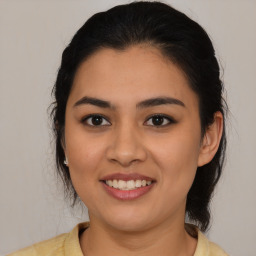 Joyful latino young-adult female with medium  brown hair and brown eyes