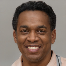 Joyful latino adult male with short  black hair and brown eyes