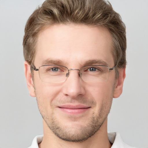 Joyful white adult male with short  brown hair and grey eyes