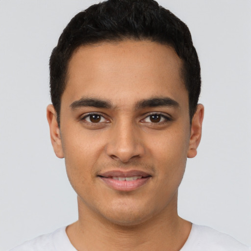 Joyful latino young-adult male with short  brown hair and brown eyes