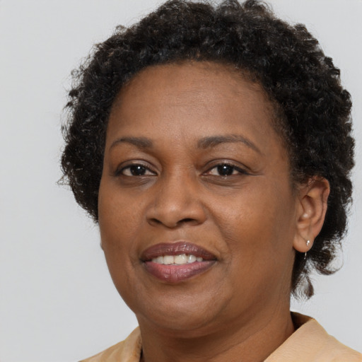 Joyful black adult female with short  brown hair and brown eyes