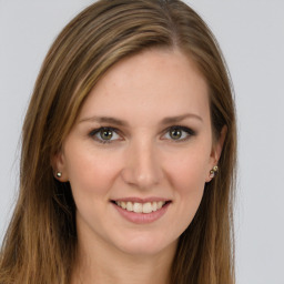 Joyful white young-adult female with long  brown hair and green eyes