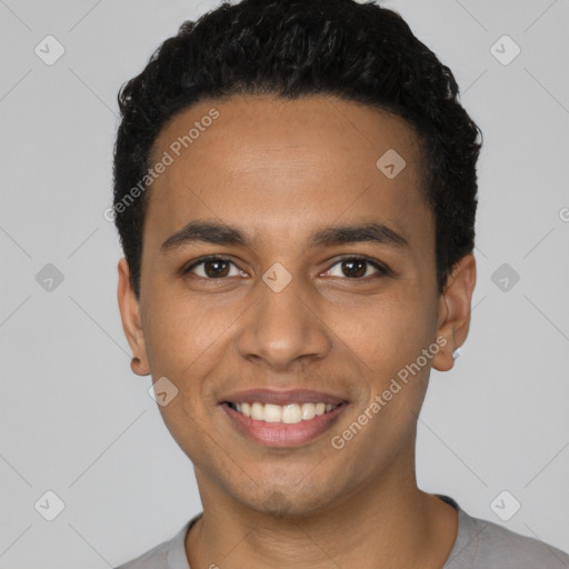 Joyful latino young-adult male with short  black hair and brown eyes