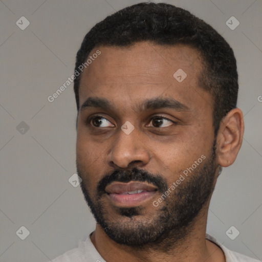 Joyful black young-adult male with short  black hair and brown eyes