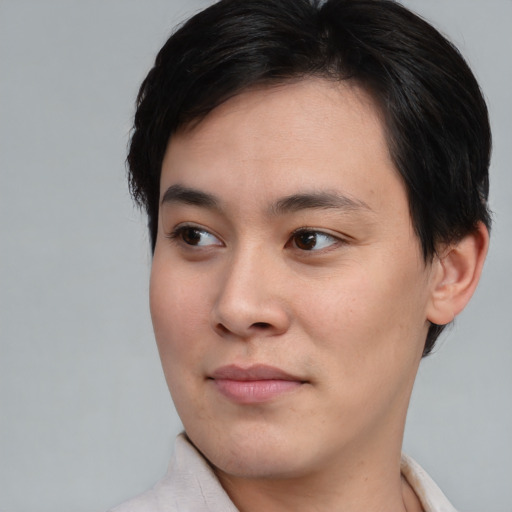 Joyful asian young-adult male with short  brown hair and brown eyes