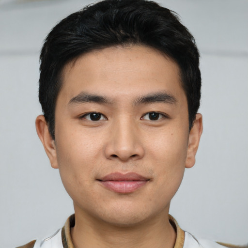 Joyful asian young-adult male with short  black hair and brown eyes