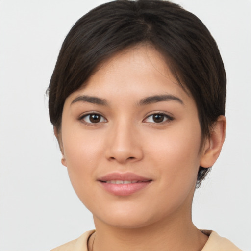 Joyful asian young-adult female with short  brown hair and brown eyes