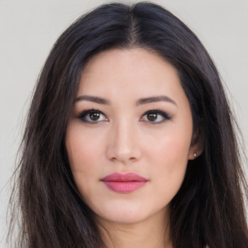 Joyful asian young-adult female with long  brown hair and brown eyes