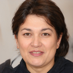 Joyful white adult female with medium  brown hair and brown eyes