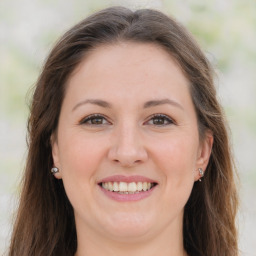 Joyful white adult female with long  brown hair and brown eyes