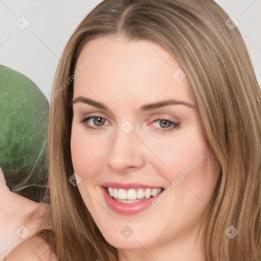 Joyful white young-adult female with long  brown hair and brown eyes