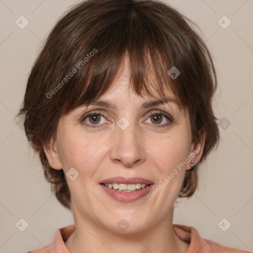 Joyful white adult female with medium  brown hair and grey eyes