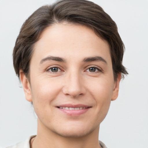 Joyful white young-adult female with short  brown hair and brown eyes