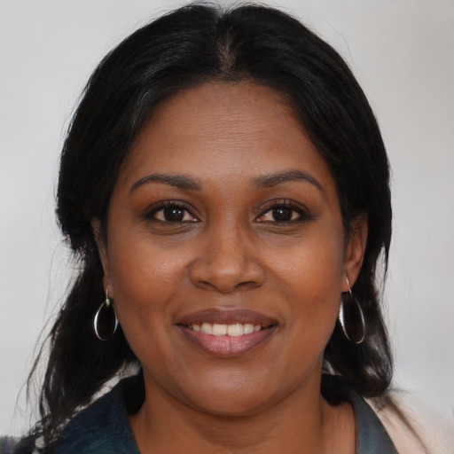Joyful black young-adult female with medium  brown hair and brown eyes