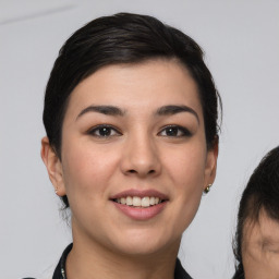 Joyful white young-adult female with medium  brown hair and brown eyes