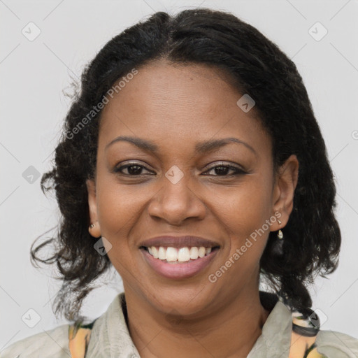 Joyful black adult female with medium  brown hair and brown eyes