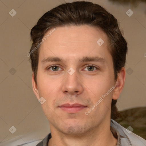 Joyful white adult male with short  brown hair and brown eyes