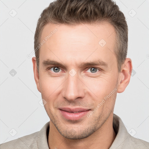 Joyful white young-adult male with short  brown hair and brown eyes