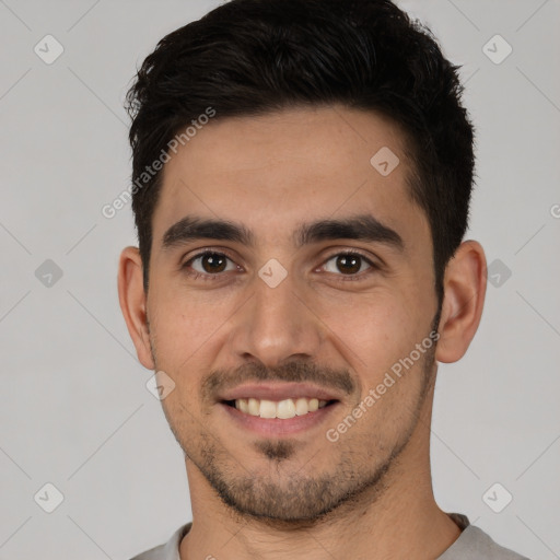 Joyful white young-adult male with short  black hair and brown eyes