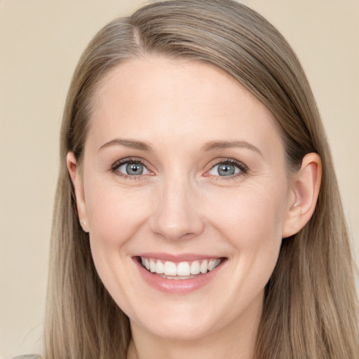 Joyful white young-adult female with long  brown hair and blue eyes