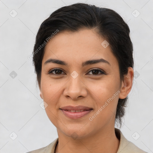 Joyful latino young-adult female with medium  brown hair and brown eyes