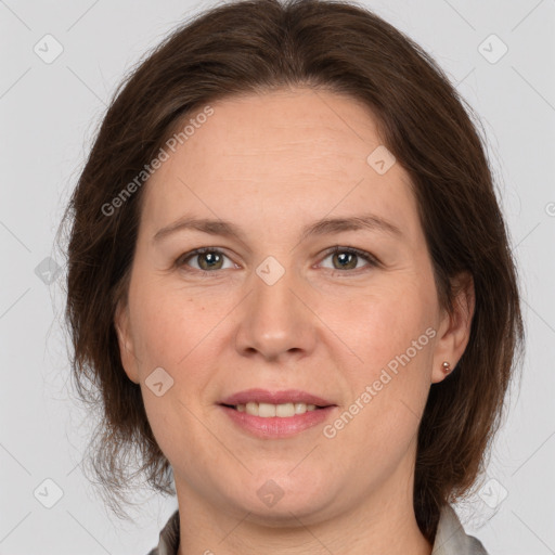 Joyful white adult female with medium  brown hair and grey eyes