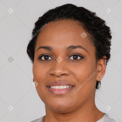 Joyful black young-adult female with short  black hair and brown eyes