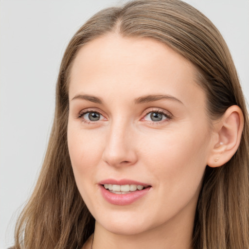 Joyful white young-adult female with long  brown hair and grey eyes