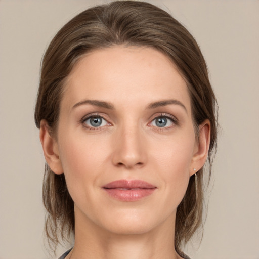 Joyful white young-adult female with medium  brown hair and grey eyes