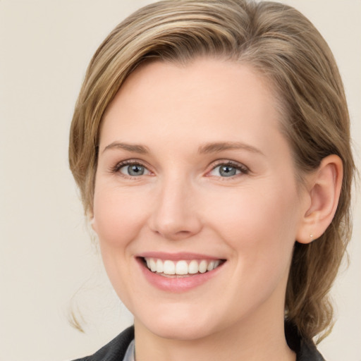 Joyful white young-adult female with medium  brown hair and blue eyes