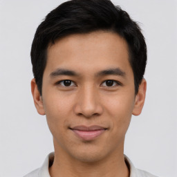 Joyful asian young-adult male with short  brown hair and brown eyes