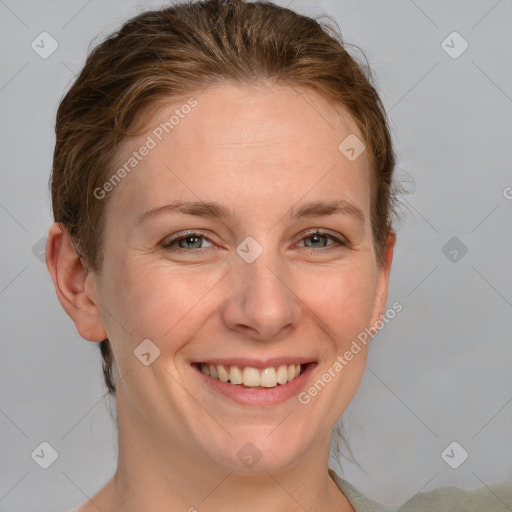 Joyful white adult female with medium  brown hair and grey eyes