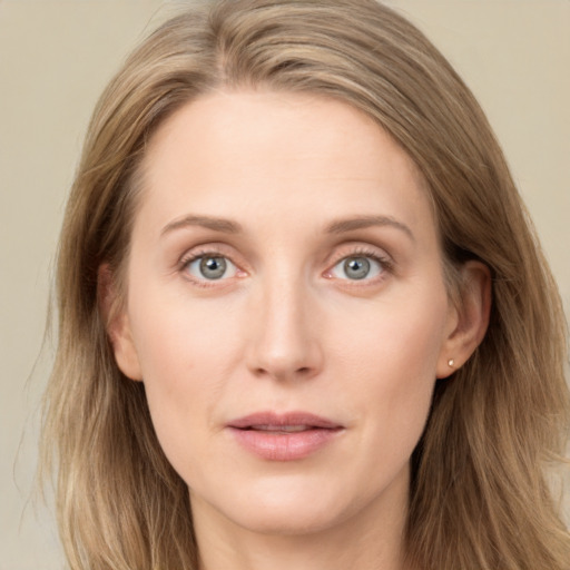 Joyful white young-adult female with long  brown hair and blue eyes