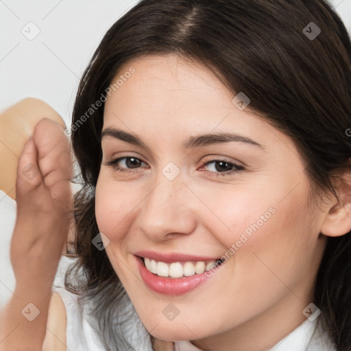 Joyful white young-adult female with medium  brown hair and brown eyes